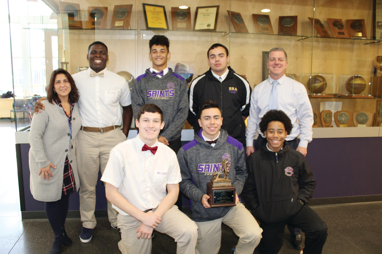 Pictured, top row: Malaina Murphy, SRA guidance counselor and football manager, Albert Guwoe, Andre Gray, Thomas Arsenault, Mike Sassi, SRA math teacher and head coach. Front row: Andrew Andella, Kai Meerbott, Makhi Goncalves.